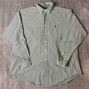 May include: A long-sleeve button-down shirt featuring a small green and white gingham check pattern. The shirt includes a button-down collar, a central button placket, and a small dark blue embroidered logo on the left chest area of the garment.