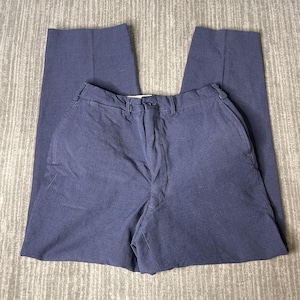May include: A pair of navy blue trousers. The pants have a classic, straight-leg design with a button and zipper closure. The fabric appears to be a medium-weight material, suitable for various occasions. The trousers are neatly folded, showcasing their tailored fit.