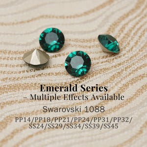 May include: Emerald series Swarovski crystals in various sizes. The image shows several faceted, round, and emerald-green crystals, along with a silver-colored, pyramid-shaped crystal. Text on the image reads "Emerald Series - Multiple Effects Available".