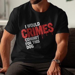 May include: Black t-shirt with the text "I WOULD CRIMES COMMIT FOR THIS DOG" in white and red. The word "CRIMES" has a dripping blood effect. The shirt is a crew neck style.