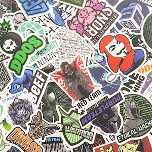 May include: A collection of colorful stickers with various designs and text. The stickers feature themes like hacking, security, and technology, with images of masked figures, code, and tech-related symbols. The stickers are in various shapes and sizes.