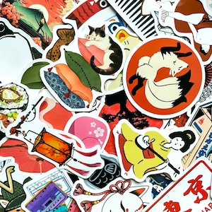 May include: A collection of Japanese-themed stickers featuring various designs. The stickers include images of a cat, a fox, sushi, a lantern, and a woman in a yellow kimono. The color palette includes red, orange, black, white, and pink.