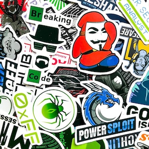 May include: A collection of colorful stickers with various designs and text. Notable stickers include a Guy Fawkes mask, a green spider, a blue dragon, and the words "Breaking" and "Power Exploit". The stickers have a tech or hacker theme.