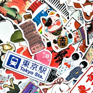 May include: A collection of colorful Japanese-themed stickers. The stickers feature a lucky cat, sushi, a Tokyo Station sign, and traditional Japanese art. The stickers are in various shapes and sizes, with vibrant colors and detailed designs.
