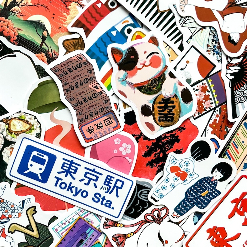 May include: A collection of colorful Japanese-themed stickers. The stickers feature a lucky cat, sushi, a Tokyo Station sign, and traditional Japanese art. The stickers are in various shapes and sizes, with vibrant colors and detailed designs.
