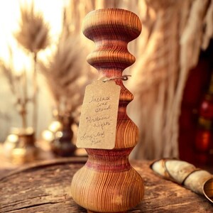 May include: A decorative wooden incense cone stand with a layered design. The stand is made of light brown wood with reddish-brown accents and a tag that reads "Incense Cone Stand" and "Arabian Nights".