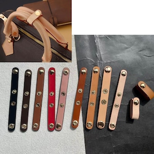 May include: Leather handle wraps in various colours, including black, brown, red, and tan. Each wrap has gold-coloured snap closures. The image also shows a brown handbag with tan handles.