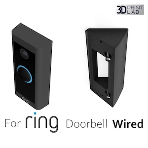 Peut inclure: Sonnette Ring Doorbell Wired noire et support de montage. La sonnette a une caméra et un anneau lumineux bleu. Le support a des trous de vis pour l'installation. Le texte "For ring Doorbell Wired" est en bas.