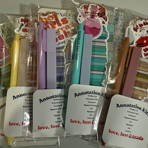 May include: Five clear plastic pouches containing annotation kits, each featuring a pen, highlighter, magnetic bookmark, and stickers. Each kit includes a card labelled Annotation Kits, love, lust & reads, with a list of contents and various book-themed stickers.
