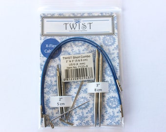 May include: A set of blue and silver Twist Short Combo knitting needles in sizes 2 and 3 inches (5 and 8 cm). The needles are packaged in a clear plastic bag with a white and blue patterned card. The card includes the brand name "Twist" and the product name "Short Combo".