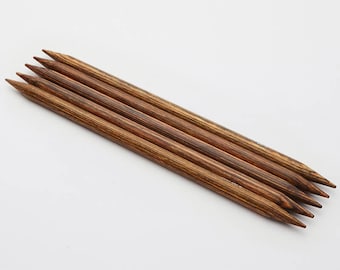 May include: Set of five wooden knitting needles with a brown and black striped pattern.