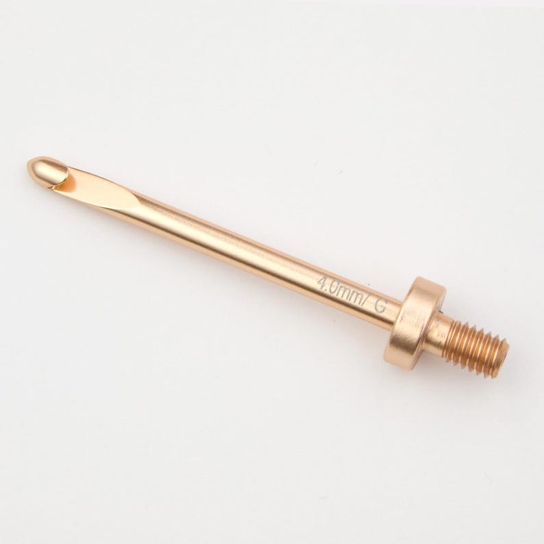 May include: A gold-coloured crochet hook with a 4.0mm G size marking. The hook has a threaded end for attaching to a handle.