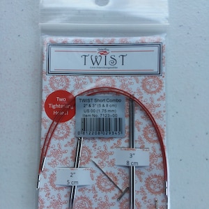 May include: A set of two interchangeable crochet needles in a clear plastic bag. The needles are 2 inches and 3 inches long, and are labeled with their size in both inches and centimeters. The needles are red and silver in color. The bag also includes a label that says "Twist Short Combo" and "US 00 (1.75 mm)".