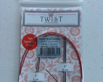 May include: A set of two interchangeable crochet needles in a clear plastic bag. The needles are 2 inches and 3 inches long, and are labeled with their size in both inches and centimeters. The needles are red and silver in color. The bag also includes a label that says "Twist Short Combo" and "US 00 (1.75 mm)".