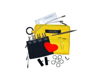 May include: A yellow ChiaoGoo knitting needle set with various metal needles, a black needle gauge, and a red heart-shaped stitch marker. The set includes a yellow zippered pouch, metal rings, and other accessories.