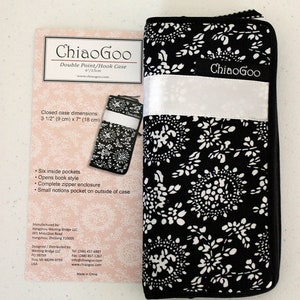 May include: Black and white double-pointed knitting needle case with a floral pattern. The case is closed and has a zipper. The case is 3 1/2 inches by 7 inches. The case is made by ChiaoGoo.