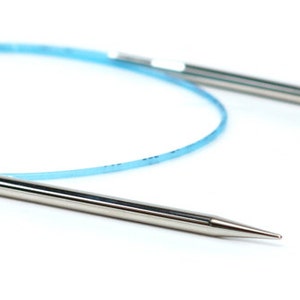 May include: A pair of silver circular knitting needles with a blue cord connecting the tips.