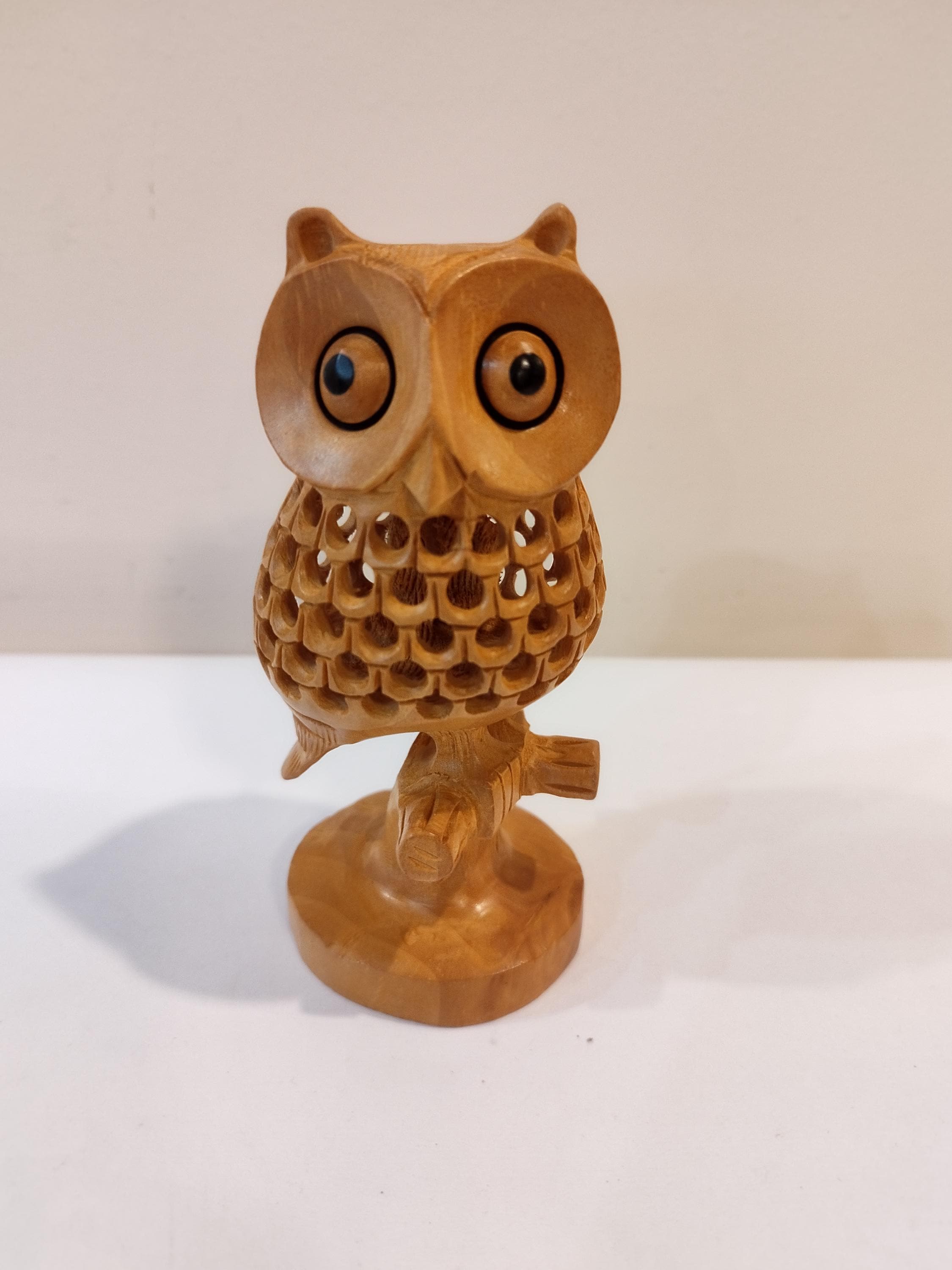 An owl on tree, one piece , five inche with a child in the net ( Stomach). Very traditional for gift