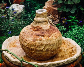 hand built earthenware water vessel with braided rope handle