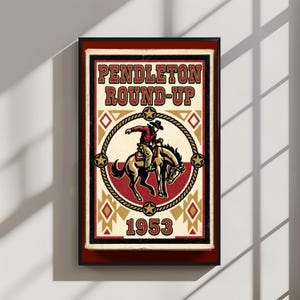 May include: A framed vintage poster with the text "Pendleton Round-Up 1953." The poster features a cowboy riding a bucking bronco inside a rope circle, with star and diamond accents. The color palette includes red, gold, and cream.