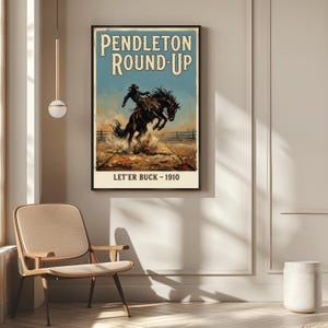 May include: A framed vintage poster for the Pendleton Round-Up rodeo, depicting a cowboy on a bucking bronco. The poster has a blue sky background with the text "Pendleton Round-Up" and "Let'er Buck - 1910".