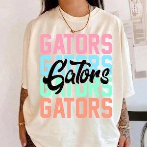 May include: A set of three ceramic mugs with a speckled, matte finish. The mugs are in shades of cream, light gray, and dark gray. Each mug has a simple, minimalist design, perfect for coffee or tea.