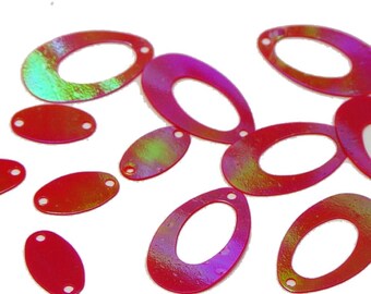 May include: A selection of iridescent red oval and teardrop-shaped sequins. The sequins have a glossy finish and small holes for sewing. Some sequins have a green and yellow sheen.