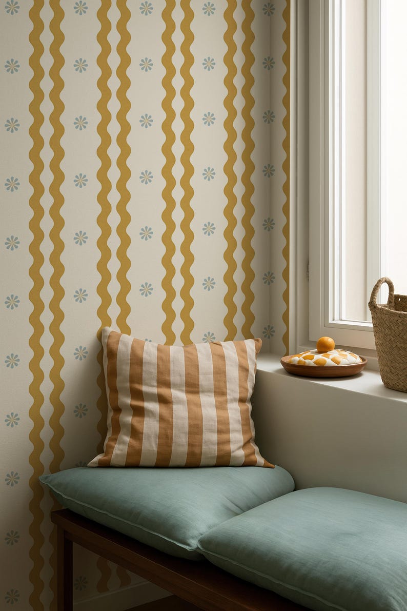 May include: A cozy corner with a striped pillow and a teal cushion on a wooden bench. The background features a cream-colored wallpaper with mustard yellow wavy stripes and small blue floral accents. A window with a basket and a wooden plate with fruit is visible.