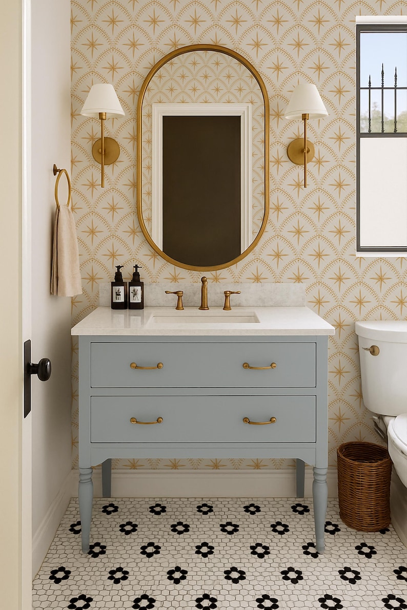 May include: A bathroom vanity with a light blue finish, two drawers, and brass hardware, topped with a white countertop, a sink, and a brass faucet. Above the vanity is an oval mirror with a brass frame, flanked by two wall-mounted lamps.