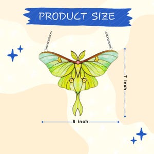 May include: A stained glass luna moth suncatcher with lime green and yellow wings, featuring a small pink center detail and a metal hanging chain. The product measures 7 inches in height and 8 inches in width as indicated by the text in the image.