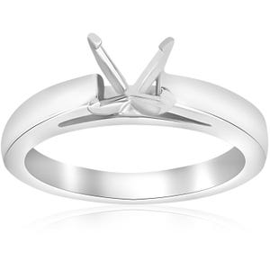 May include: A polished silver ring with a prong setting designed to hold a gemstone. The ring features a smooth, rounded band and a four-prong setting, ideal for a solitaire diamond or other precious stone. The ring is displayed on a white background.