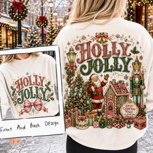 May include: A cream-coloured sweatshirt featuring a festive graphic print. The back displays a detailed holiday scene with Santa Claus, a nutcracker, a decorated Christmas tree, gifts, and the text Holly Jolly and Sweet Christmas Magic.