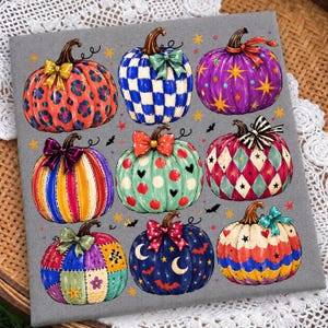 May include: A grey fabric square featuring a grid of nine illustrated pumpkins with various patterns including leopard print, blue and white checks, purple stars, colourful stripes, polka dots, diamonds, patchwork, moons, and scalloped edges.