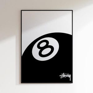 May include: Framed art print in black and white, depicting a stylized eight-ball. The number eight is in a white circle, set against a black background. The Stussy logo is in the lower right corner.