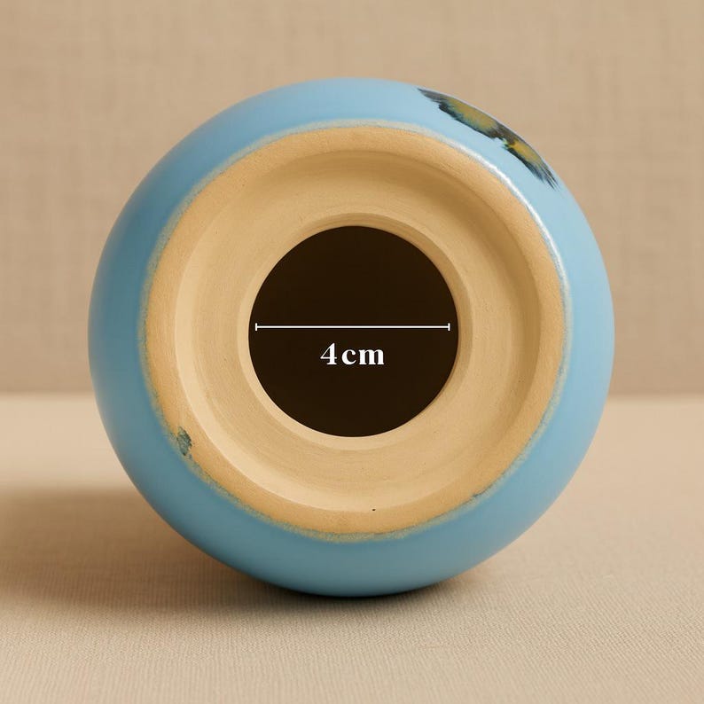 Custom golden retriever urn with the name “Leki,” painted in sunny ochre with cartoon-style charm. The urn has smooth curves, floppy ears, paw etchings, and a bold turquoise collar that contrasts beautifully against golden fur tones. Crafted entirely by hand, this urn recreates your pet’s likeness from photos and personality notes, making it the only one like it in the world. Holds ashes of medium to large dogs.