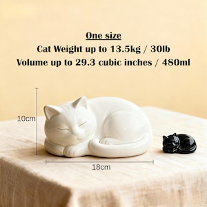 A personalised curled sleeping cat ceramic urn shaped by hand to hold ashes securely with a fitted base plug. Custom painted from photos to recreate your cat’s markings and colours. Sized for pets up to 30lb, this memorial urn is perfect for cat cremation remembrance, handmade pottery collectors, and anyone looking for a calming, curled pose feline sculpture as a unique custom ashes container.