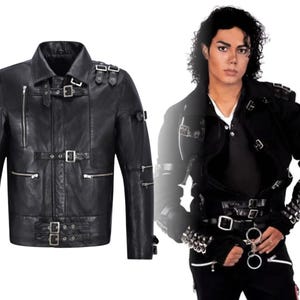 May include: Black leather jacket with multiple silver buckles and zippers. The jacket has a classic collar and a fitted silhouette. The image also shows a person wearing a similar jacket, showcasing the design and fit.