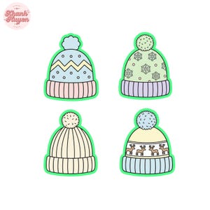May include: Four colorful winter hat designs with pom-poms. The hats feature various patterns, including zigzags, snowflakes, and reindeer. Each hat has a different color scheme, with shades of blue, pink, green, and cream. The hats are outlined in green.