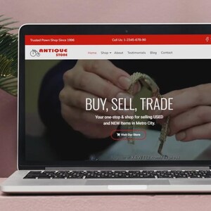 May include: A laptop screen shows an antique store website. The site's headline reads "BUY, SELL, TRADE" and promotes selling USED and NEW items in Metro City. The website's header is red, displaying the store's logo and contact details.