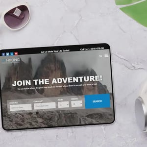 May include: A tablet showing a hiking website with the words "JOIN THE ADVENTURE!". White sunglasses and headphones are placed beside the tablet. The website includes a search function. The background is a marble surface.