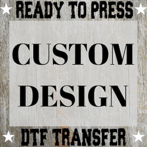 May include: A DTF transfer design with the text "READY TO PRESS" at the top and "DTF TRANSFER" at the bottom. The words "CUSTOM DESIGN" are in the center, all in bold black font. The background is a weathered wood texture.