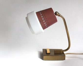 1960s mid-century table lamp.  Perforated pink-red steel, white glass, brass.