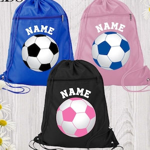 May include: Three drawstring soccer bags in blue, pink, and black. Each bag features a soccer ball graphic and the word "NAME" in white. The bags have a zippered pocket and a drawstring closure.