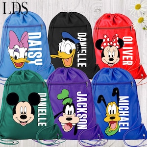 May include: Six drawstring backpacks in blue, black, red, green, purple, and royal blue. Each bag features a Disney character graphic, including Daisy Duck, Donald Duck, Minnie Mouse, Mickey Mouse, Goofy, and Pluto, with a name printed in white.