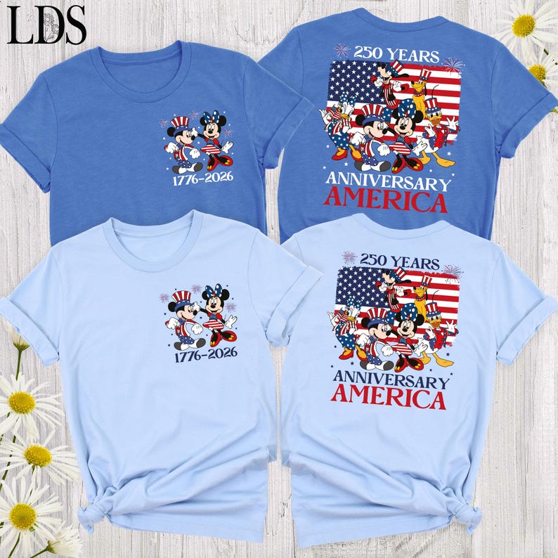 May include: Two blue t-shirts featuring Mickey and Minnie Mouse in patriotic outfits. The front shows the characters with the text 1776-2026. The back displays the characters with an American flag, the text 250 YEARS ANNIVERSARY AMERICA, and fireworks.