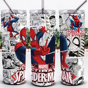 May include: A cylindrical stainless steel tumbler featuring a black and white comic book print with red and blue Spider-Man illustrations. The design includes the text Marvel Ultimate Spider-Man in red and white, a clear lid, and a metal straw.
