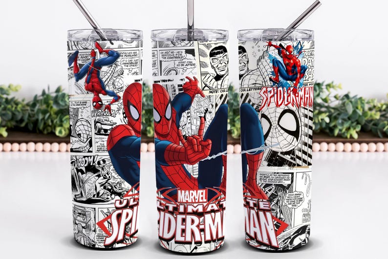 May include: A cylindrical stainless steel tumbler featuring a black and white comic book print with red and blue Spider-Man illustrations. The design includes the text Marvel Ultimate Spider-Man in red and white, a clear lid, and a metal straw.