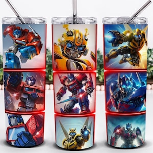 May include: Three stainless steel tumblers featuring images of Transformers characters. Each tumbler has a different design, including Optimus Prime and Bumblebee, with a red border and a silver straw.