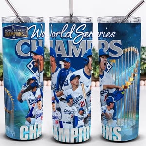 May include: A blue and white tumbler featuring the text "World Series Champions" and images of baseball players. The design includes the team logo and a trophy, with a silver straw.