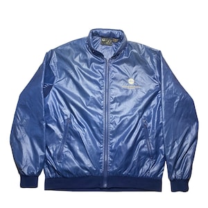 May include: A shiny, blue bomber jacket with a full zipper closure, two front pockets, and a ribbed hem and cuffs. The jacket has a small logo on the chest. The jacket is made of a lightweight, possibly nylon, material.